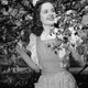 CIRCA 1950s: Woman standing by tree in bloom. (Photo by George Marks/Retrofile/Getty Images